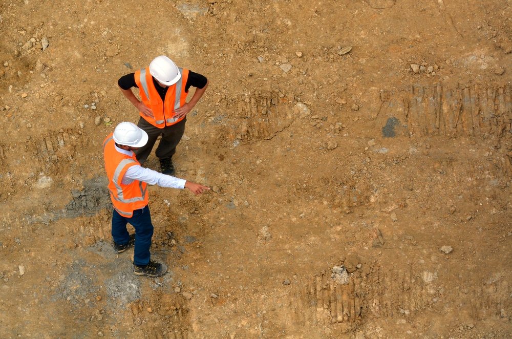 Aerial,View,Of,Two,Unrecognized,Civil,Engineers,Inspecting,An,Empty